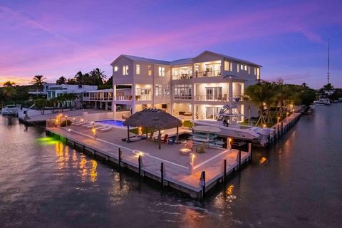 BRAND-NEW CUSTOM-BUILT OCEANFRONT RESORT-STYLE HOME! This exquisite home features panoramic ocean views with a cut-in boat slip, a 25,000 lb. boat lift, plus 380 ft. of travertine marble dock with electric and water. There is a custom beach entry poo...