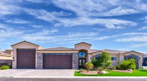 Introducing a luxurious Lake Havasu Island retreat - a prestigious Toscana gated community Home of Distinction that boasts 3,270 sq ft of contemporary opulence with four bedrooms and four bathrooms. Step into a grand entrance, a spacious blend of pri...