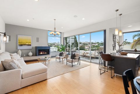 Discover luxury living in this award-winning modern townhome, now refreshed and professionally staged to highlight its stunning features. Nestled high above the prestigious Manhattan Beach Hill Section, away from the street, this home offers panorami...