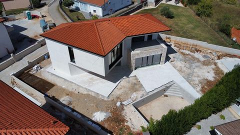 In the vicinity of Poreč, upon a plot of land measuring 678 square meters, there shall rise a villa of notable distinction, encompassing a total area of 169.30 square meters. The villa, a structure of two floors, shall present on its ground level a g...