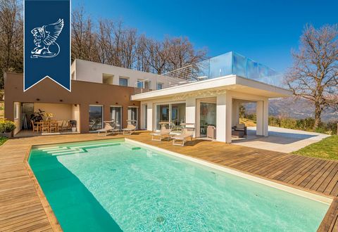 This luxurious modern villa with a pool is for sale by the sea of the Versilia area, in a charming hilly position in Massarosa, not far from Lucca's town centre. Located in a quiet and very leafy residential area, this splendid property was comp...