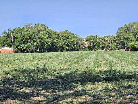 Discover the potential of this expansive 5-acre alfalfa field, perfectly suited for a variety of uses. Zoned A-1 agricultural with coveted ditch irrigation rights (JR water rights), this property offers a rare chance to realize your dreams. Whether y...