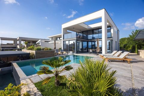 A beautiful luxury villa with a pool is located on an island on the island of Krk, in a private street and surrounded by luxury villas. The elegant villa offers panoramic sea views and is breathtaking with its modern architecture and impeccable execu...