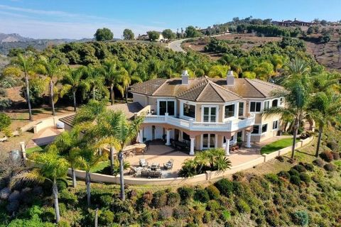 Exquisite Mediterranean masterpiece with a stunning entrance, boasting breathtaking views. This custom-built home sits on 2.5 acres adorned with a thriving avocado orchard, providing both luxury and a taste of nature. Nestled in a secure gated commun...