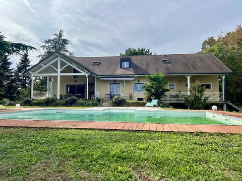 FOR SALE in the town of ST LAURENT DE MURE (69720): On the heights of the town, come and discover this large family house of about 267 m2 located in a quiet and wooded area on a plot of about 23000 m2. Including: * Ground floor: A master bedroom of a...
