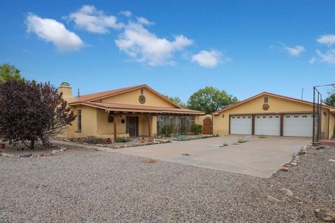 Discover this custom-built adobe home on a sprawling 4.19-acre lot in the Belen community. Step inside to find wood beam vigas, spacious living areas bathed in natural light, and a custom kiva fireplace. The expansive chef's kitchen features ample ca...