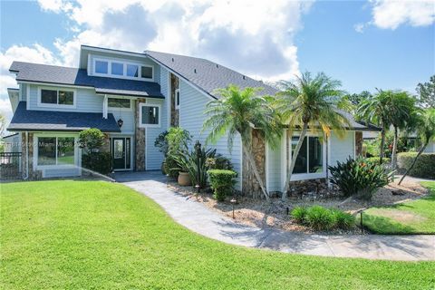 Over 450 ft WATER FRONTAGE! NO HOA! This is truly a RARE OPPORTUNITY! Breathtaking panoramic water views on a secluded 1.15 AC lakefront corner lot. This stunning 4-bedroom 3-bathroom home has been meticulously updated into a beautiful coastal design...