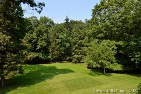 Beautiful 2 acre lot with meadow and gently flowing stream. Close to town on West Side location.