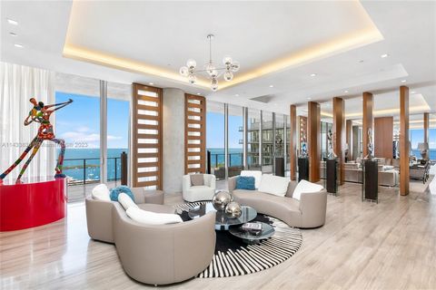 Discover Miami's grandest single-floor condo in Miami, spanning 11,000 sq. ft with 12' ceilings. This penthouse, designed by Nick Luaces, showcases 6 beds, 6 baths, 2 powder rooms, a theater, library, office, and distinct seating zones. Boasting Bang...