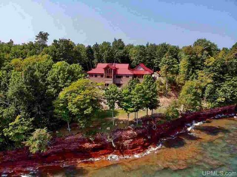 Exquisite living awaits you at this stunning Lake Superior retreat. Situated on a 10-acre wooded lot with 258 ft of Lake Superior frontage, this two-level masterpiece was architecturally designed to maximize every inch of its 5,895 sq ft. The exterio...