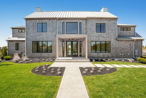 Welcome to a world of unparalleled luxury and modern elegance in the prestigious enclave of Quogue. Nestled along the serene shores of the Hamptons, this magnificent new waterfront residence epitomizes refined living at its finest. Boasting breathtak...