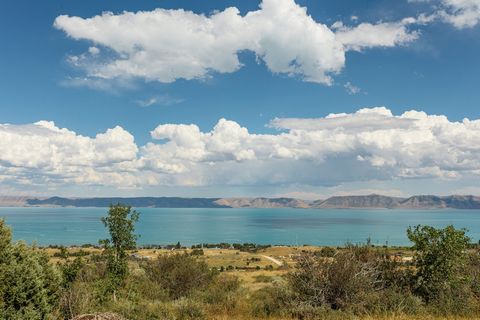 This scenic property, spanning 3.56 acres, offers a stunning vantage point above Bear Lake with breathtaking views of the lake and the surrounding mountains. It presents a rare opportunity for both serene living and investment potential. The parcel i...