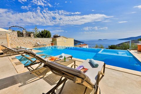 5-Bedroom Detached Villa with Private Pool in Kalkan Kaş The interior features an open-plan living room with a large smart TV, a fully equipped modern kitchen, and a dining area for eight. The kitchen includes a refrigerator, freezer, built-in microw...