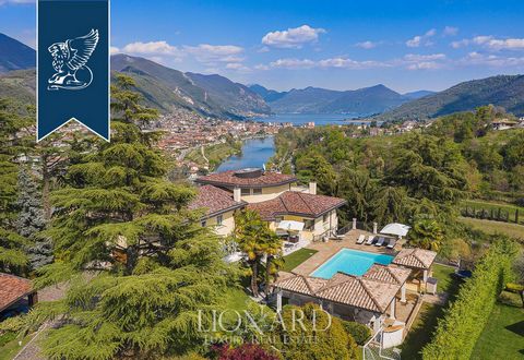 This stunning villa for sale in the province of Bergamo is in an extraordinary hilly position with beautiful views of Lake Iseo, surrounded by a complex with a big park with a pool. The house for sale stands out for its size and charm: with its 710 s...