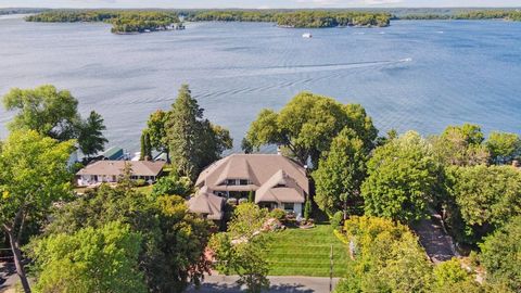 Rare lakeshore opportunity, walkable to Excelsior. Enjoy 128 feet of prime, northwest facing frontage, offering panoramic views of Lake Minnetonka year-round! A Steiner & Koppelman/Mike Sharratt collaboration brought forth this luxury English Cotswol...