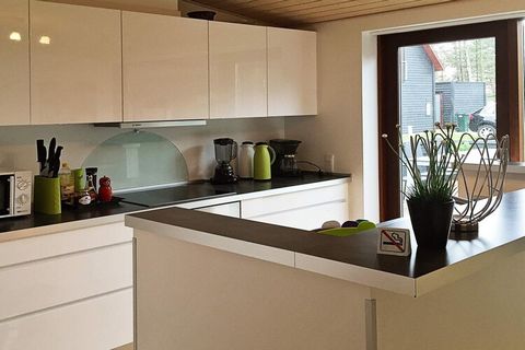 An exclusive and architectural designed holiday cottage of high quality materials, and whirlpool for 2 persons and sauna. The house is bright and spacious and has 2 bathrooms, whereas one of them has the spa facilities. The functional kitchen is equi...