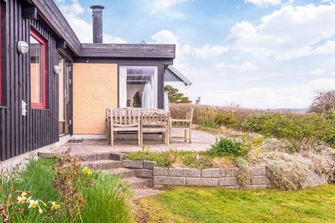 Completely renovated cottage with a view of the sea at Mørkholt. There are terraces almost all around the house and in the middle of the garden, so you can enjoy the view and the sun all day. The cottage is located in a quiet area by a very child-fri...