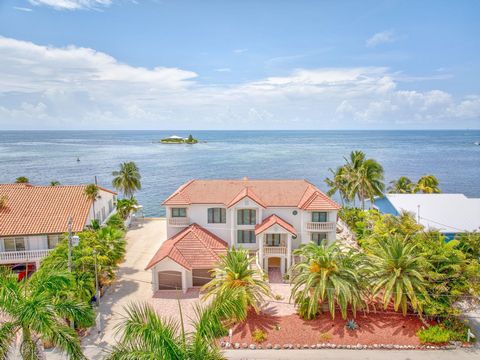 Rising majestically above the sparkling Atlantic, this Concrete Fortress on Marathon's prestigious Ocean E peninsula redefines luxury coastal living. Located within an exclusive gated community of only 16 homes, the residence offers unrivaled privacy...