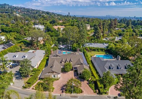 Located in a prime Beverly Hills, just North of Sunset Blvd. This exceptional property offers a unique opportunity for customization into a dream home. The residence features a formal entry that opens to a resort-style backyard with a large pool and ...