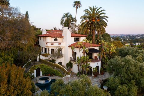 Surrounded by white-washed walls and sited behind grand privacy gates, this one-of-a-kind Spanish Colonial Revival, seamlessly blending the grandeur of Mediterranean estates with the allure of old Hollywood glamour, is an unparalleled testament to an...