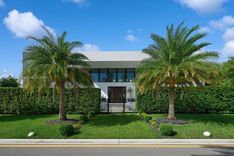 Exquisite oasis nestled in Miami Beach's prestigious Hibiscus Island on an oversized lot. This home has an open-concept layout with 22FT ceilings, high-end finishes, wine cellar, & grand living area for relaxation & entertainment. A chef-inspired kit...