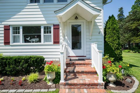 Discover this charming home adjacent to the beach, boasting exquisite architectural details that evoke a sense of timeless elegance. The focal point of the living room is the Vintage Greenport Brick fireplace, a rare find that adds both texture and v...