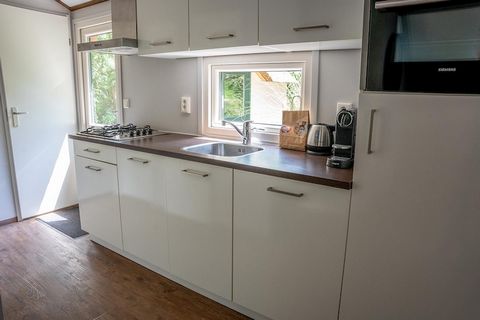Escape to a cozy farmhouse-style cottage in the heart of nature, ideal for those seeking peace, privacy, and comfort. This charming cottage, for four people, offers the perfect retreat at Holiday Park De Heivlinder, surrounded by the serene Speulderb...