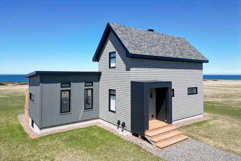 In Étang-des-Caps, this unique house combines traditional charm with contemporary design. The large windows and open spaces allow natural light and panoramic views of the surrounding area, the sea, and the sunsets, since the rear of the house points ...