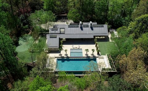 Who would imagine that a property such as this could exist in the heart of Atlanta? From the moment you approach the property, serenity abounds with a tree lined driveway taking you deep into a ten-acre wooded forest where wildlife encompasses you. D...