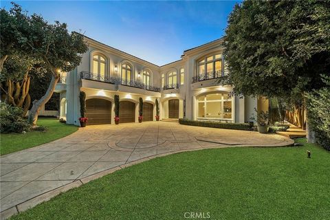This superbly modernized approximately 7,070 square foot guard-gated Bel Air Crest residence showcases refined materials, exquisite finishes, and impeccable decor throughout. Breathtaking grand entry with a chandelier suspended from the cathedral cof...