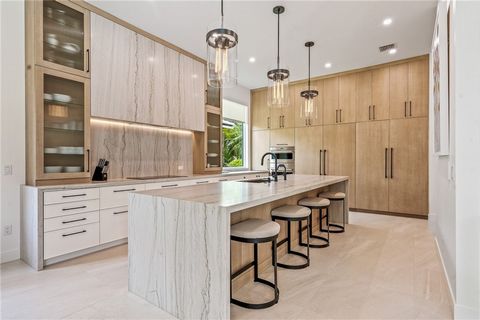 Miami designer puts his touch on this property like no other! Warm South Beach reno-stunning kitchen-Custom Amish craftsmen cabinets floor to ceiling, quartzite island/backsplash, Wolf & Miele appliances & Scandinavian inspired laundry room! Carefull...