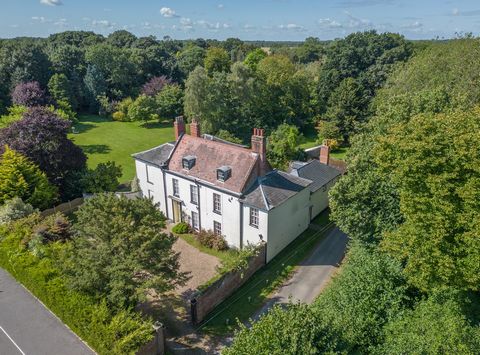 This handsome Grade II listed Georgian home has wonderful proportions and a host of elegant original features. Sitting in approximately 2 acres of glorious gardens and woodland, just over a mile inland from a popular beach, it’s a delightful family h...