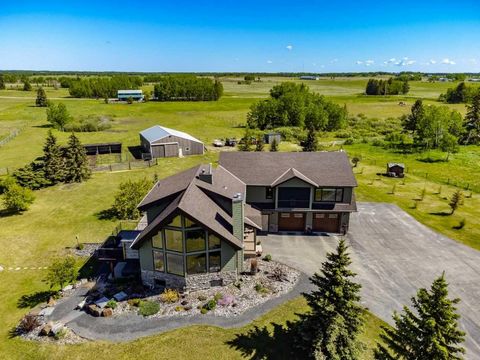 Discover this one-of-a-kind property just 15 minutes north of Cochrane, nestled on 30 scenic acres with breathtaking panoramic mountain views. This estate features two incredible homes, each offering its own distinctive charm and luxury. The larger h...