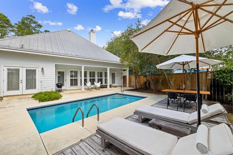 Prominently positioned just a few homes back from the turquoise-hued waters on 30A, this charming coastal cottage spans two distinct levels totaling over 2,200 square feet and includes a private pool and deeded beach access. Tucked behind the lush ve...