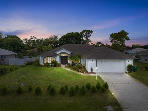 Florida Pool Paradise! Bright, open & move-in ready! NEWER roof, soaring arched ceilings, white tile & wood laminate floors. Re-piped .Triple sliders lead to a sparkling screened pool & private lanai-complete with cabana bath + outdoor shower! Chef's...