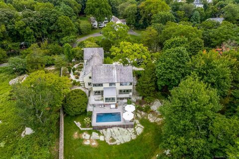 Secluded, modern hilltop retreat overlooking Holly Pond and the salt marsh. Nearly 3 acres on a private road adjacent to Darien Land Trust property and Weed Beach Park. Designed by David Austin for his personal residence in 2003. This 5-bedroom 3.5 b...