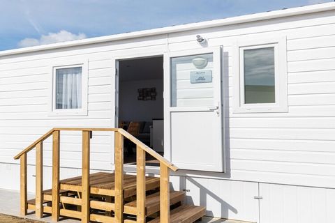 Stay in this cosy chalet located in a park in Middelkerke with your family. The park has a lot of facilities like a playground with swings for kids, a football ground, and a lot of interesting activities. The chalet also features a well-furnished gar...
