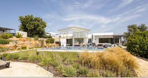 This pleasant contemporary home boasts a spacious outdoor area with a private pool. The elegantly equipped, open-plan kitchen and living room feature large windows that provide light and views of the covered pool and the property's garden. The master...