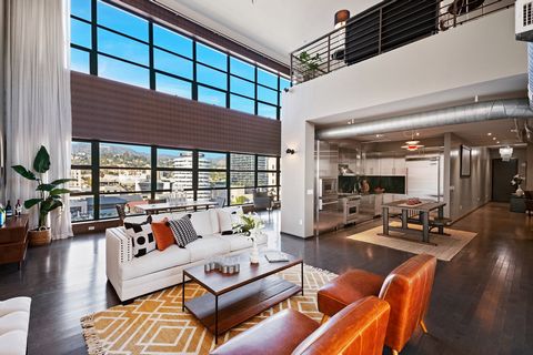 Welcome to The Broadway #1008, a sophisticated two-story penthouse loft located in the heart of Hollywood, CA. This unique residence is situated within an iconic landmark building, offering unparalleled panoramic views through two stories of sleek gl...