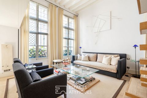 In the heart of the prestigious Carré des Antiquaires district, a few steps from the Seine, this apartment with a house spirit and quality services develops its unique charm on 186 m2 on the ground (135.93 m2 Carrez law) spread over several levels. I...