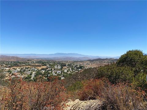 Get off the grid! A great opportunity to build your hilltop dream home with views sparkling Lake Elsinore in the distance. 20 Acres of undeveloped land above The Farm devopment in Wildomar. Currently gated and a dirt road takes you through the chappa...