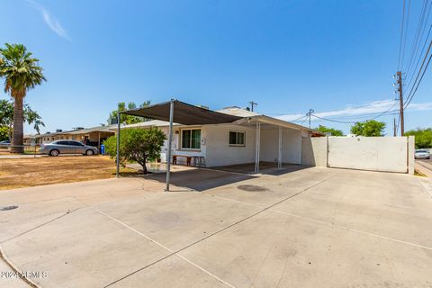 Fantastic opportunity to own this charming solid block home nestled on a North/South facing corner lot! Providing 2 carport parking, RV gate & parking, and an extended driveway. Discover a formal living room, perfect for receiving guests! Natural lig...