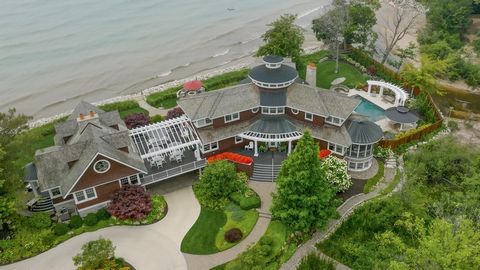 Enjoy your own abounding sunsets at this private beachfront estate! Situated on almost 5 acres, this remarkable property sits on 300 feet of Lake Michigan shoreline. This spacious home offers room for everyone with 6 generously sized bedroom ensuites...