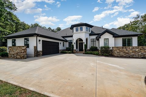 This European/Modern home sits on nearly 1/2 acre in The Peninsula community. Perfect for entertaining, it offers an open floor plan with lush views, a heated saltwater pool, and a gourmet kitchen with custom cabinets and Brazillian Quartzite counter...