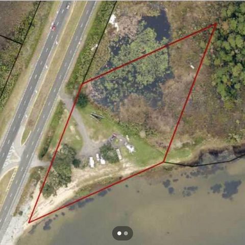 Unlock the potential of this rare 4-acre (approx. 16,145 m²) waterfront lot located directly on Highway 90 , one of Pace’s main thoroughfares. With unmatched visibility and high traffic exposure, this property is ideal for commercial development, a c...