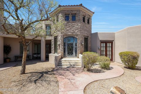 Welcome home to your very own piece of paradise nestled in the scenic Estrella Mountain foothills. This eclectic 5070 sq ft. custom home sits on 1.25 acres, and features a fully owned 25.6kw solar panel system. Just beyond the front door of this gorg...